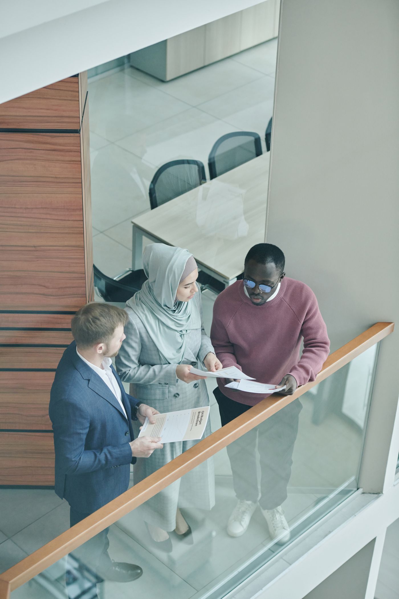Three colleagues reviewing documents together